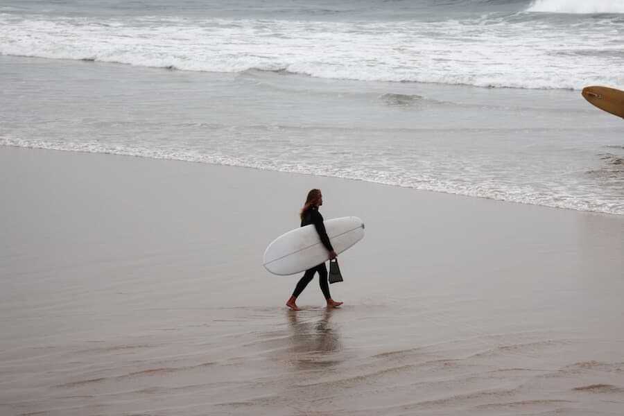 Surfer walking on beach